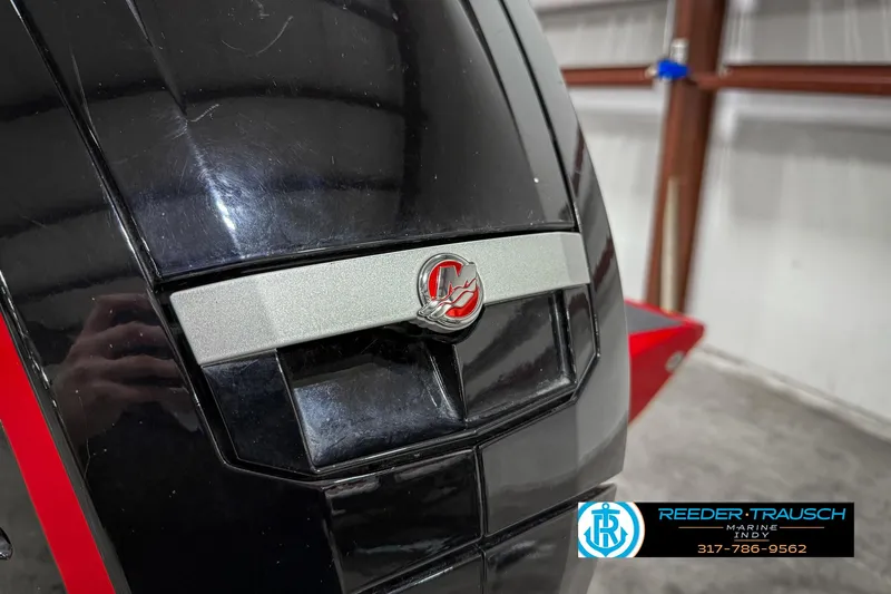 Slide: The Image of Close-up of 2018 Triton 18 TX boat engine in a garage setting. - 49