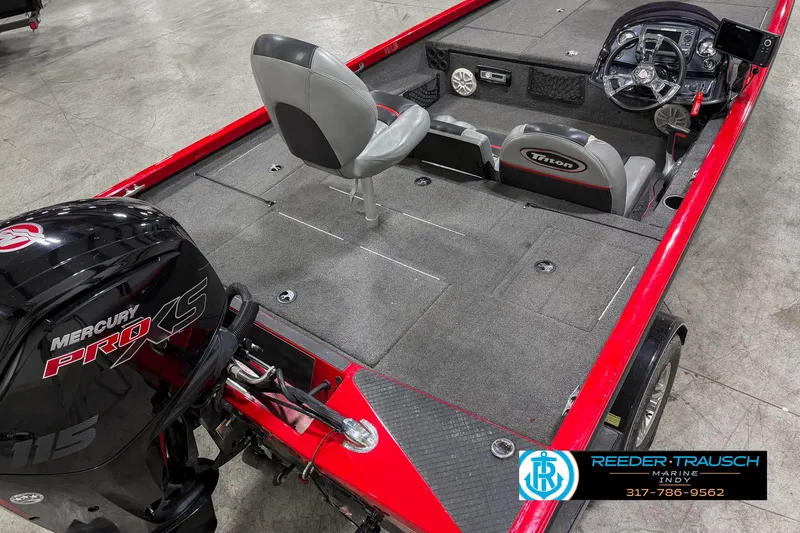 Slide: The Image of 2018 Triton 18 TX boat interior with Mercury Pro XS engine, gray seating, and red accents. - 9