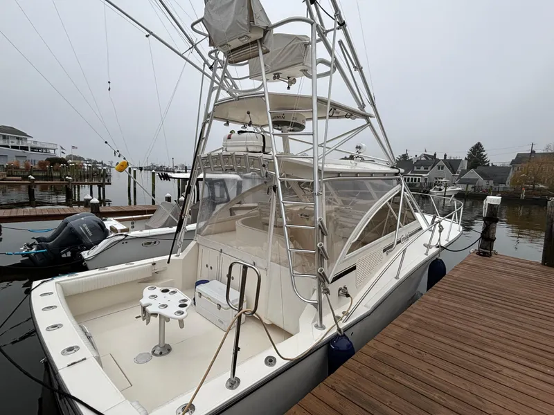 The Image of 2006 Carolina Classic 35 boat docked, featuring a spacious deck and tower. - 0