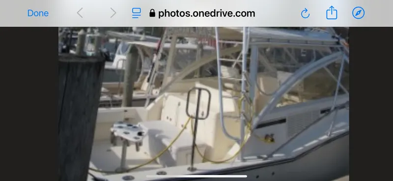 Slide: The Image of 2006 Carolina Classic 35 boat docked, featuring a spacious deck and fishing equipment. - 10
