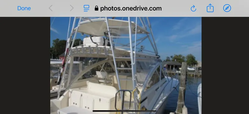 Slide: The Image of 2006 Carolina Classic 35 boat docked at marina, featuring a spacious deck and tower. - 12