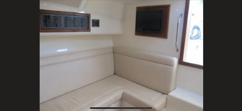 Slide: The Image of Interior of 2006 Carolina Classic 35 boat with beige seating and wall-mounted electronics. - 15
