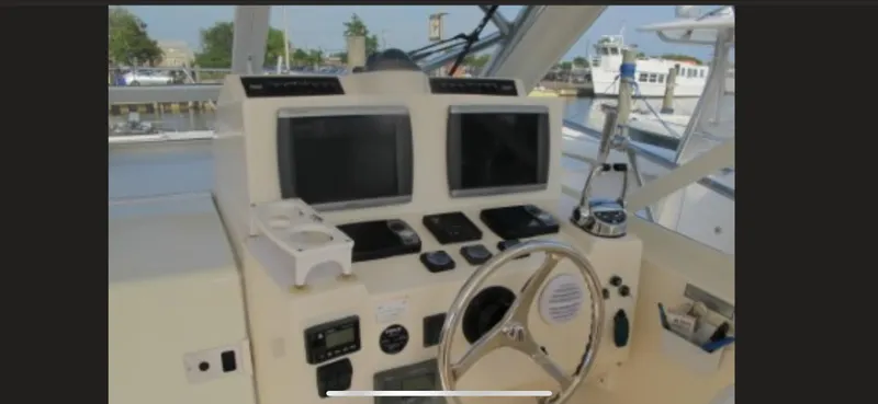 Slide: The Image of Helm of 2006 Carolina Classic 35 boat with dual screens and steering wheel. - 19