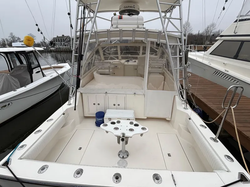 Slide: The Image of 2006 Carolina Classic 35 boat with spacious deck and fishing setup, docked at marina. - 4