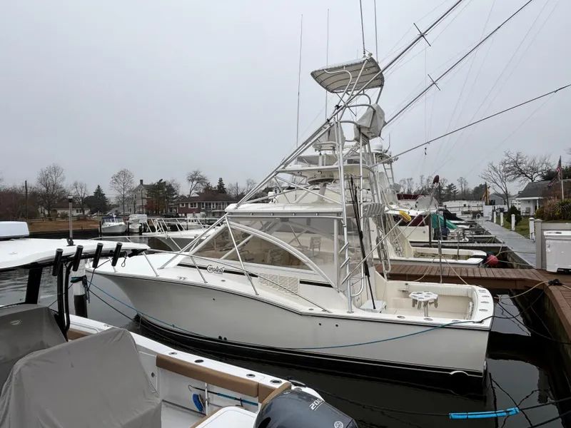 Slide: The Image of 2006 Carolina Classic 35 boat docked at a marina on a cloudy day. - 6