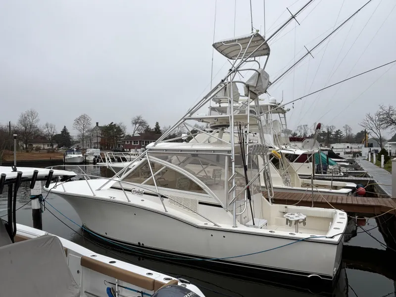 Slide: The Image of 2006 Carolina Classic 35 boat docked in a marina on a cloudy day. - 7