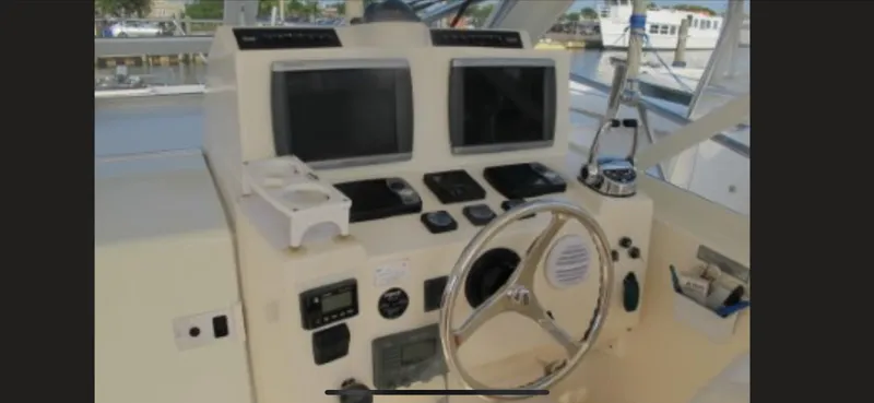 Slide: The Image of Helm of 2006 Carolina Classic 35 boat with dual screens and steering wheel. - 8