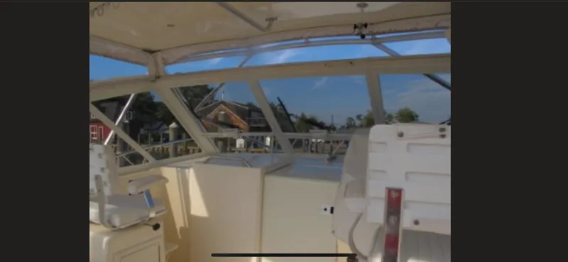 Slide: The Image of Interior view of a 2006 Carolina Classic 35 boat, featuring helm and seating area. - 9