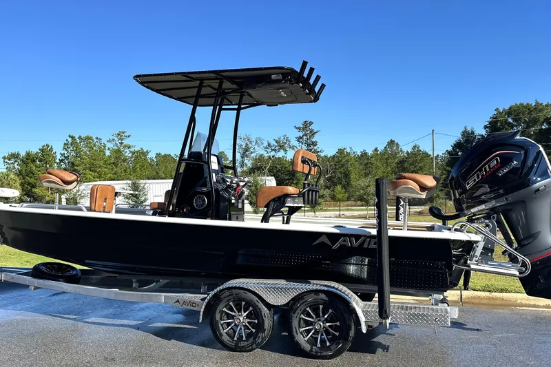 The Image of 2026 Avid 23 Fusion boat on trailer, featuring sleek design and powerful engine. - 0