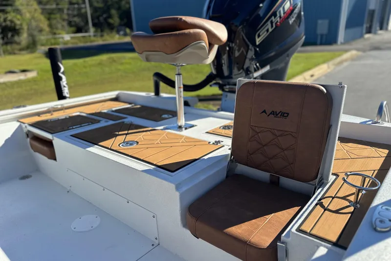 Slide: The Image of 2026 Avid 23 Fusion boat interior with brown leather seats and modern design. - 10