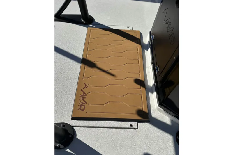 Slide: The Image of Brown deck mat on 2026 Avid 23 Fusion boat, featuring logo and textured design. - 15