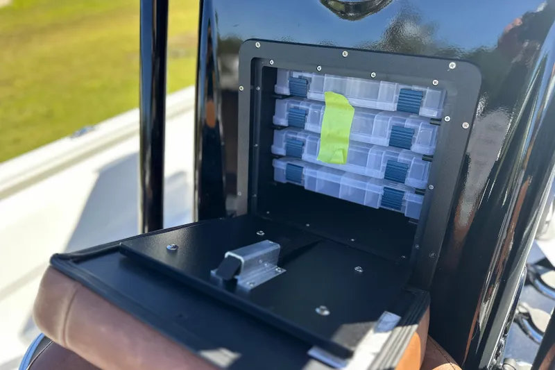 Slide: The Image of Storage compartment on 2026 Avid 23 Fusion boat, featuring organized tackle boxes. - 18