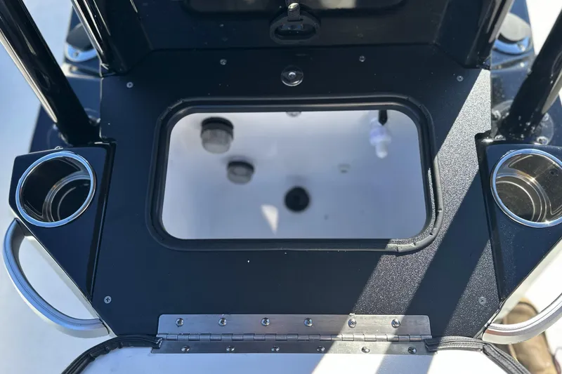Slide: The Image of Open storage compartment on 2026 Avid 23 Fusion boat with cup holders. - 19
