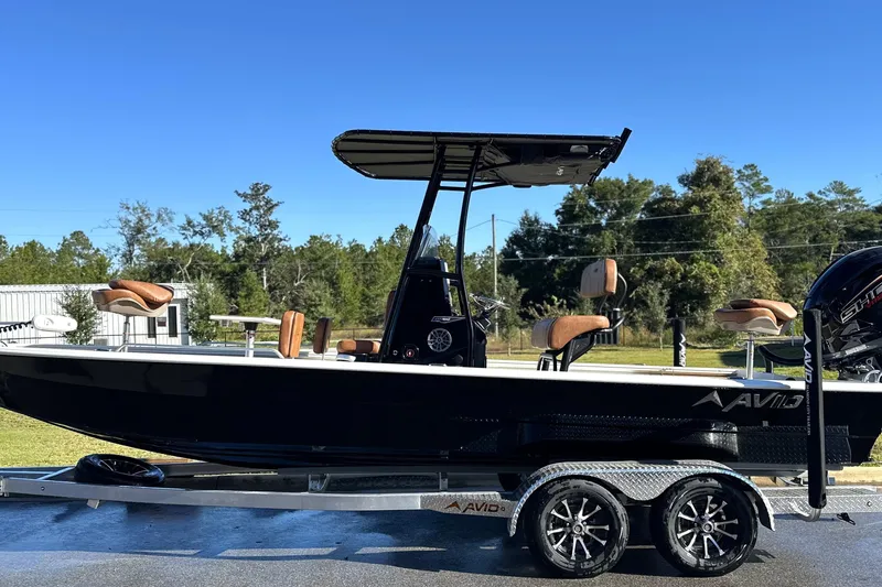 Slide: The Image of Avid 23 Fusion 2026 boat on trailer, sleek design, sunny day background. - 2