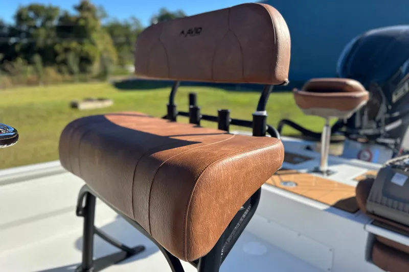Slide: The Image of 2026 Avid 23 Fusion boat seat with brown leather upholstery, outdoor setting. - 22