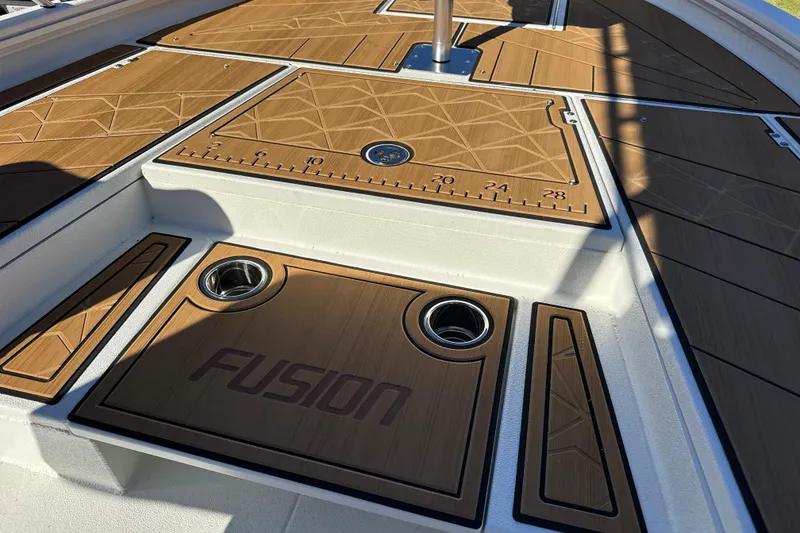 Slide: The Image of 2026 Avid 23 Fusion boat deck with wood finish and measurement markings. - 27