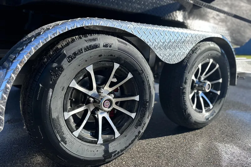 Slide: The Image of Close-up of 2026 Avid 23 Fusion trailer wheels with diamond plate fender. - 32