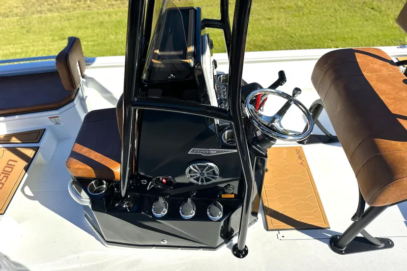 Slide: The Image of 2026 Avid 23 Fusion boat interior with sleek console and brown seating. - 4