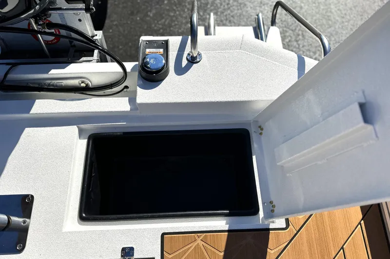 Slide: The Image of Open storage compartment on 2026 Avid 23 Fusion boat deck. - 7