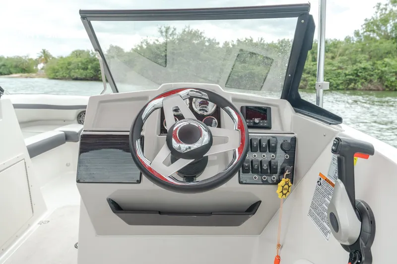 Slide: The Image of 2024 Starcraft SVX 190 OB DC boat dashboard with steering wheel and control panel. - 5