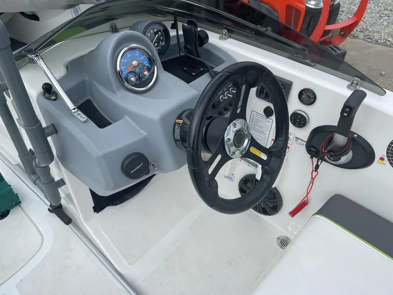 Slide: The Image of 2021 Tahoe T18 boat dashboard with steering wheel and control panel. - 13
