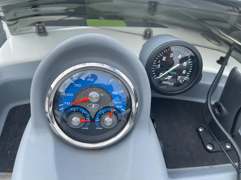 Slide: The Image of Dashboard of a 2021 Tahoe T18 boat with speedometer and RPM gauges. - 15