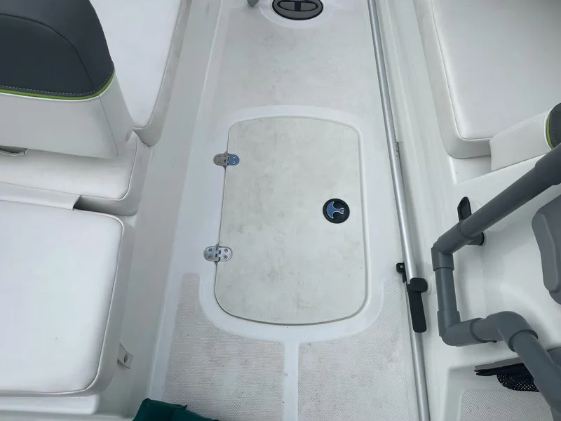 Slide: The Image of 2021 Tahoe T18 boat interior with white seating and storage compartment. - 21