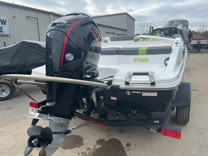 Slide: The Image of 2021 Tahoe T18 boat with outboard motor, parked on a trailer. - 4