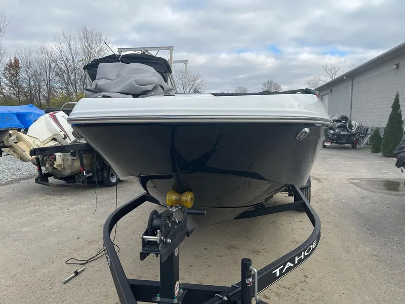 Slide: The Image of 2021 Tahoe T18 boat on trailer, parked outdoors on a cloudy day. - 6