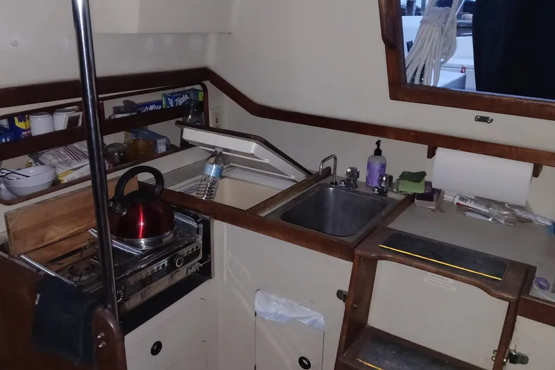 Slide: The Image of Compact galley kitchen in 1983 C&C 29 MkII sailboat with sink, stove, and kettle. - 6