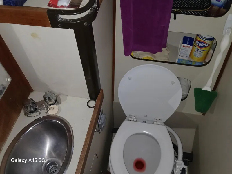 Slide: The Image of Compact bathroom in a 1983 C&C 29 MkII sailboat with sink and toilet. - 7