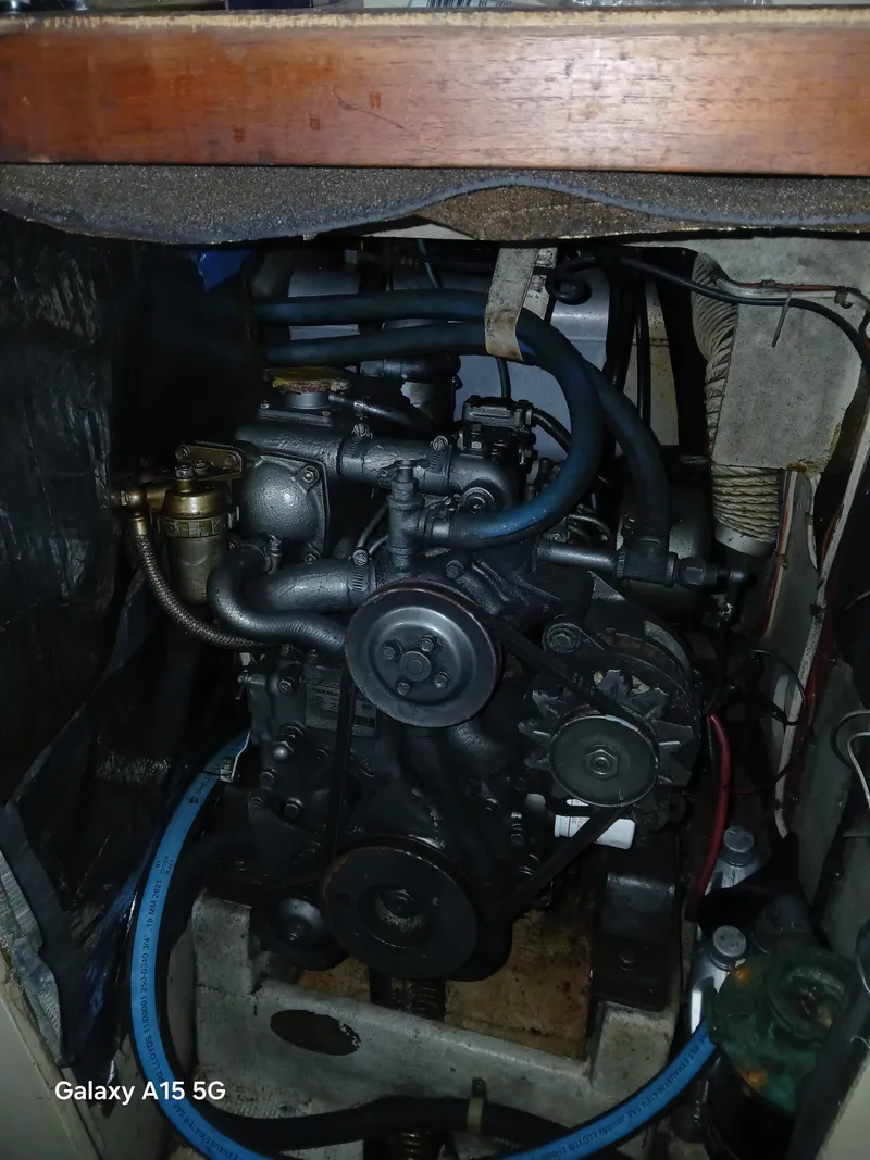 Slide: The Image of Engine compartment of a 1983 C&C 29 MkII sailboat, showcasing mechanical components and hoses. - 8