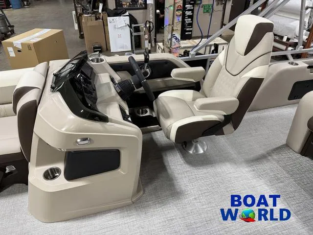Slide: The Image of 2025 Tahoe LTZ 2385 Swingback boat interior with captain's chair and console at Boat World. - 10