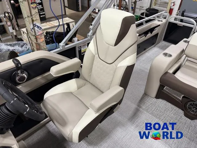 Slide: The Image of 2025 Tahoe LTZ 2385 Swingback boat interior with premium seating and steering wheel. - 11