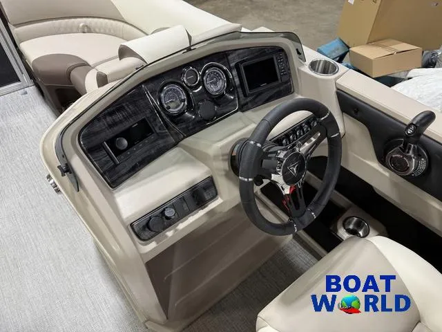 Slide: The Image of 2025 Tahoe LTZ 2385 Swingback boat dashboard with steering wheel and controls. - 12