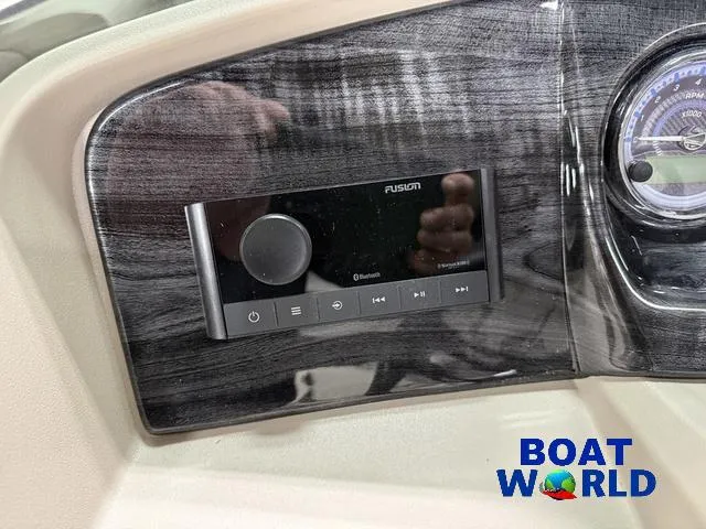 Slide: The Image of 2025 Tahoe LTZ 2385 Swingback dashboard with Fusion audio system, Boat World logo visible. - 13