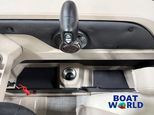 Slide: The Image of 2025 Tahoe LTZ 2385 Swingback boat interior with control panel and cup holder. - 16