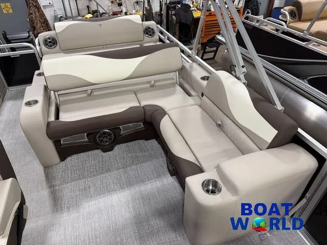 Slide: The Image of 2025 Tahoe LTZ 2385 Swingback interior with beige and brown seating, cup holders, and speakers. - 18