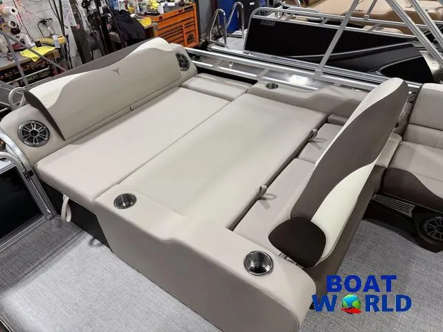 Slide: The Image of 2025 Tahoe LTZ 2385 Swingback boat interior with beige seating and cup holders. - 19