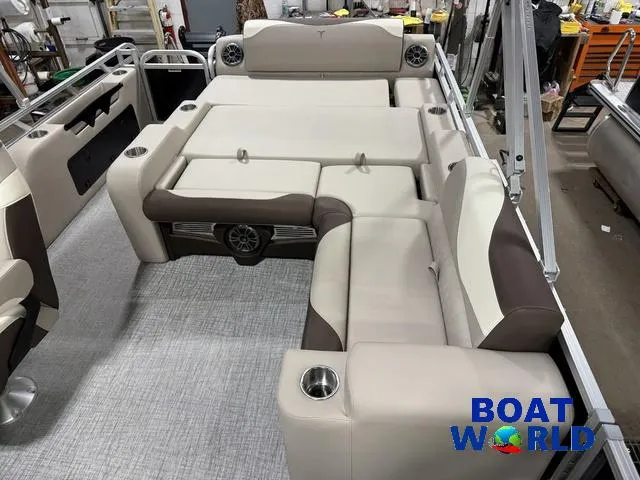 Slide: The Image of 2025 Tahoe LTZ 2385 Swingback interior with beige and brown seating, featuring cup holders and speakers. - 20