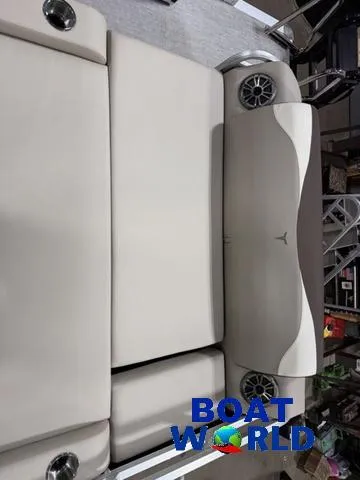 Slide: The Image of 2025 Tahoe LTZ 2385 Swingback boat interior with beige seating and speakers. - 22