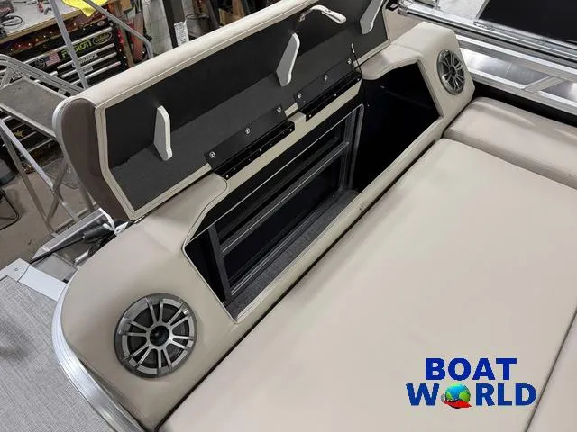Slide: The Image of 2025 Tahoe LTZ 2385 Swingback boat interior with speakers and storage compartment. - 23