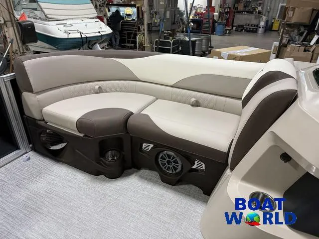 Slide: The Image of 2025 Tahoe LTZ 2385 Swingback interior with beige and brown seating in a showroom. - 33