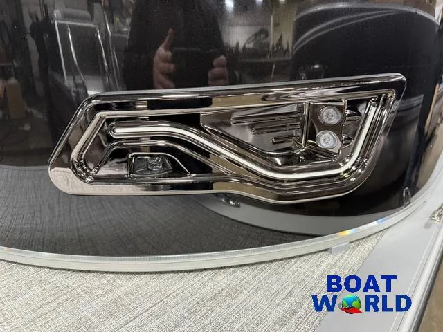 Slide: The Image of 2025 Tahoe LTZ 2385 Swingback boat detail with sleek chrome accents at Boat World. - 37