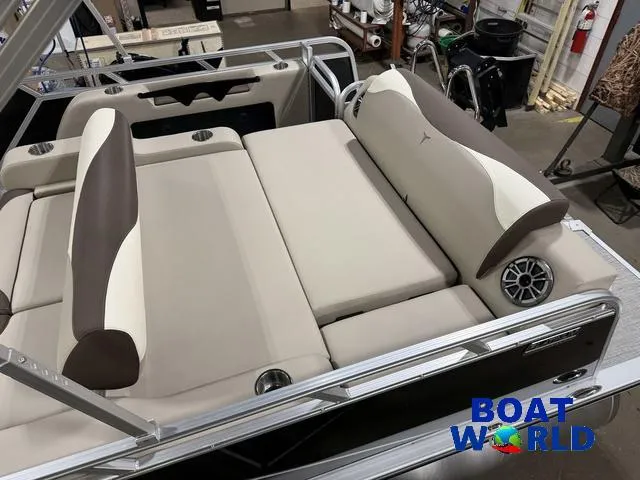 Slide: The Image of 2025 Tahoe LTZ 2385 Swingback boat interior with beige and brown seating, cup holders, and speakers. - 5
