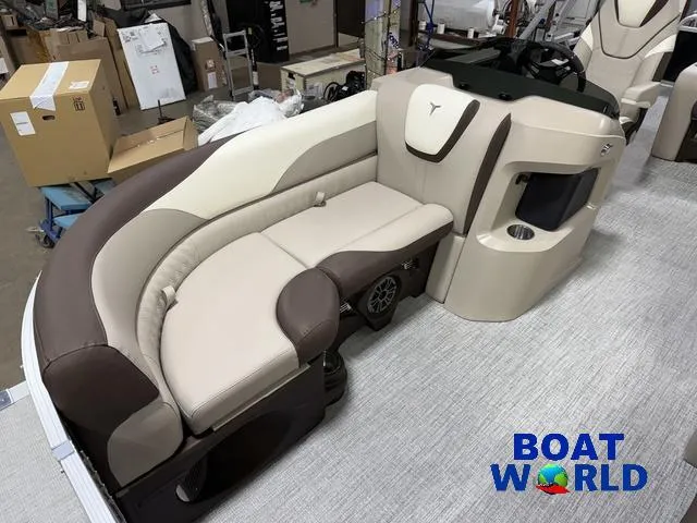 Slide: The Image of 2025 Tahoe LTZ 2385 Swingback interior with beige and brown seating, showcased at Boat World. - 8