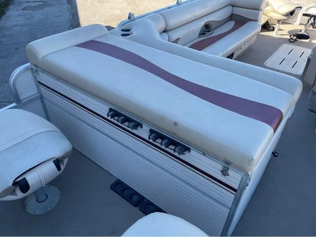 Slide: The Image of 2009 G3 LX 322FC boat interior with cushioned seating and storage compartments. - 10