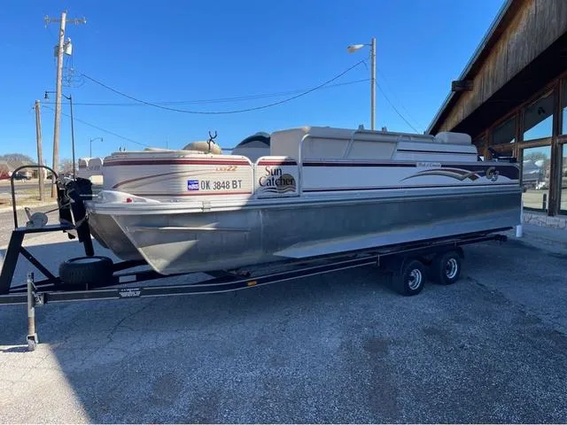 Slide: The Image of 2009 G3 LX 322FC pontoon boat on trailer, parked outdoors. - 2