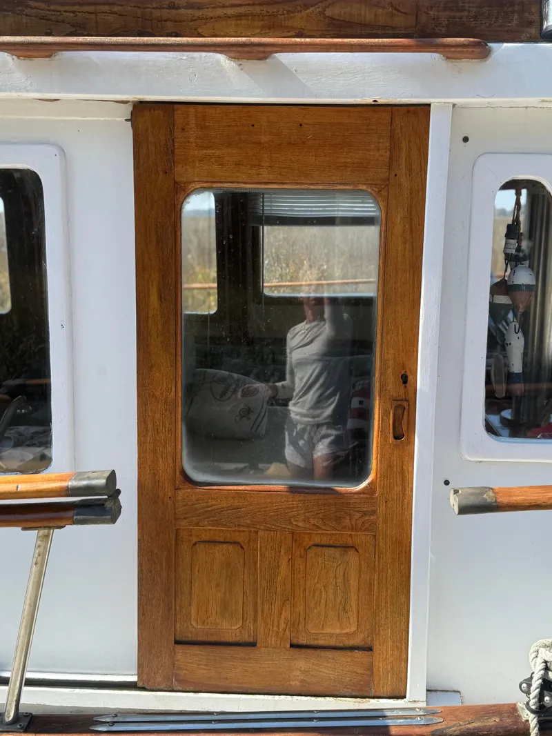 Slide: The Image of 1979 Marine Trader Double Cabin with wooden door and windows, showcasing classic nautical design. - 13