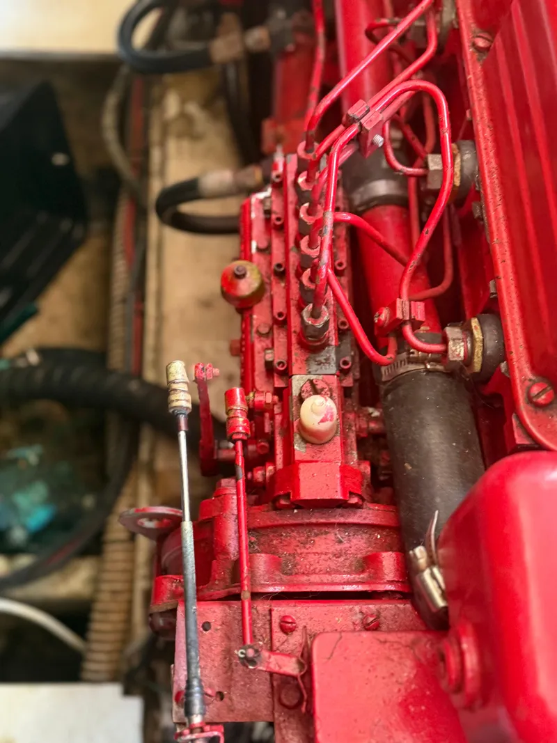 Slide: The Image of Close-up of a red engine component in a 1979 Marine Trader Double Cabin boat. - 17